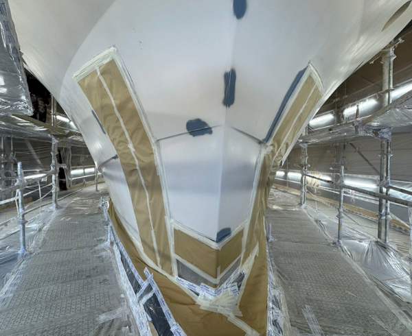 Superyacht hull masked and prepared for coating