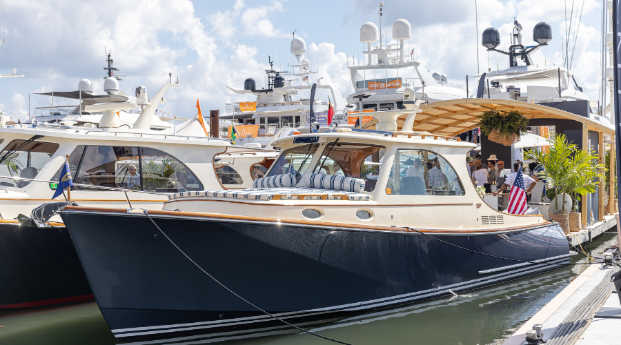 Hinckley luxury motor yacht moored at a marina, showcasing its premium Awlgrip® exterior finish.