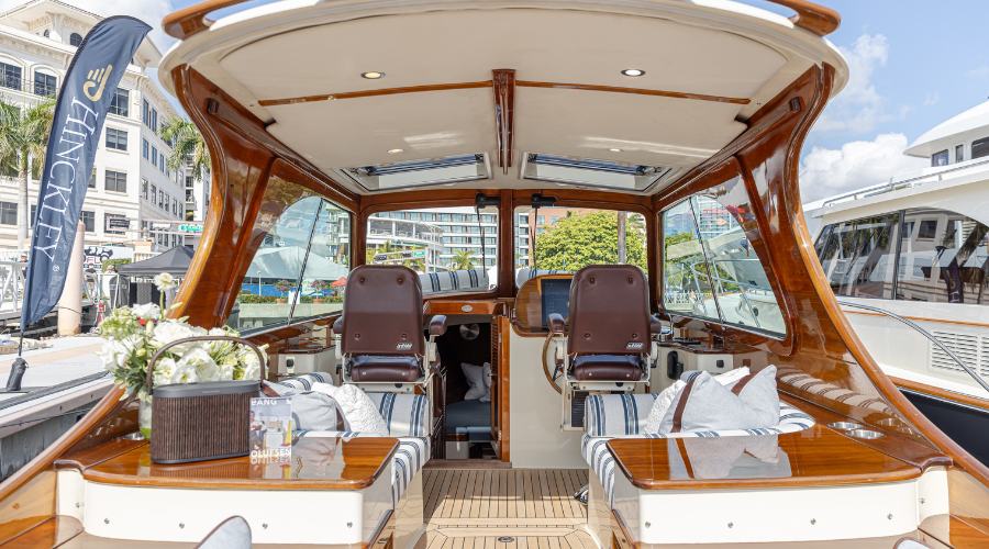 Interior of a Hinckley luxury motor yacht showcasing premium craftsmanship, timber finishes and helm station.